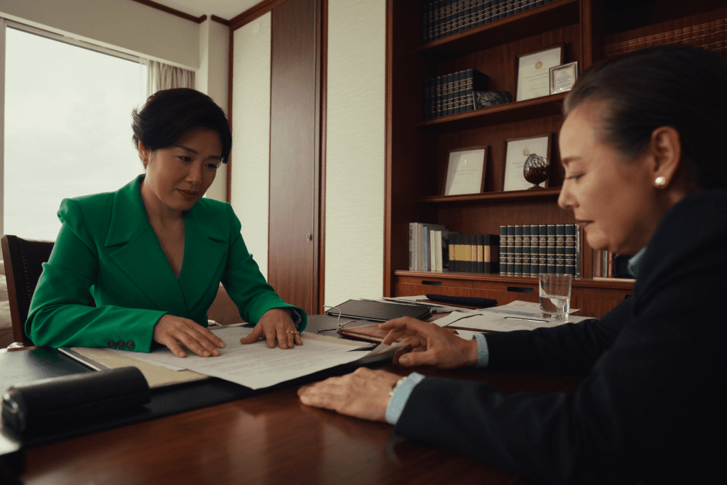 An immigration consultant reviewing documents with a client across a desk