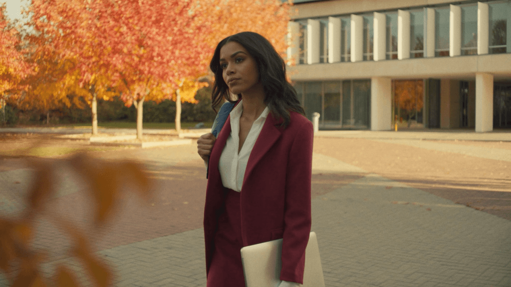 A woman standing outside a Canadian building on an autumn day